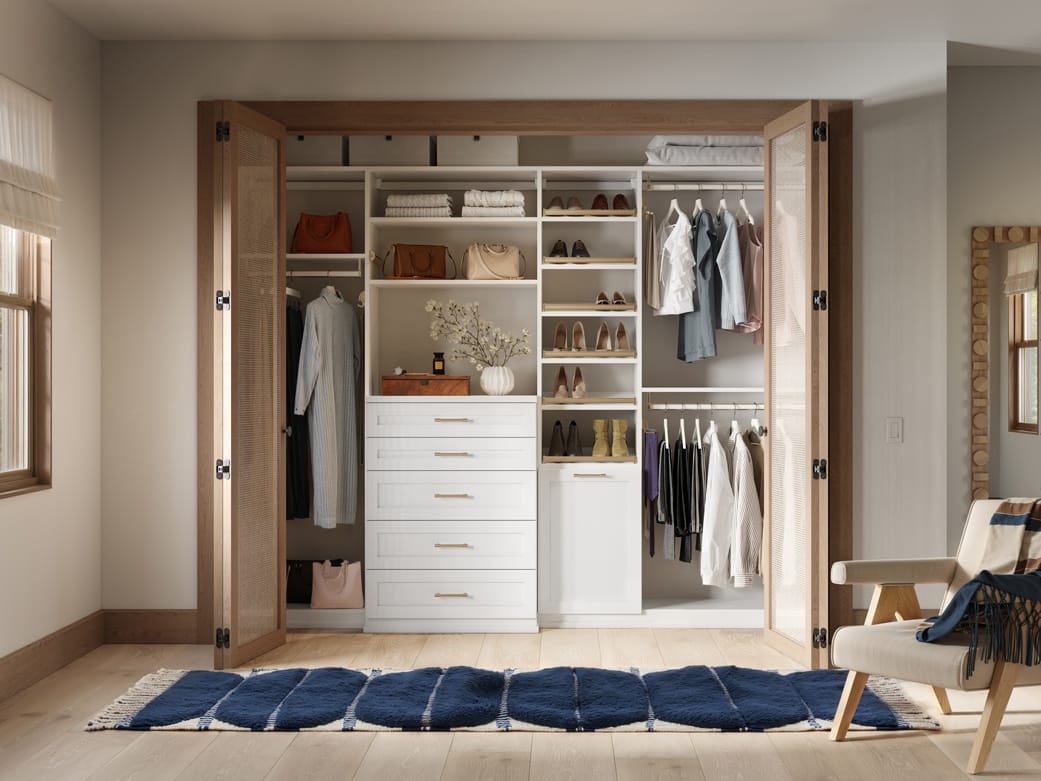 Reach in closet design, to floor custom shelving and dresser by California Closets
